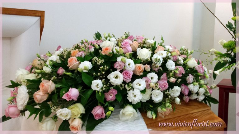 Delicate pink and peach casket spray