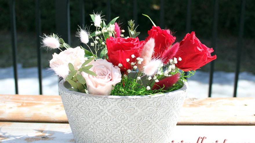 Red and pink eternal roses in clay vase for Montreal area