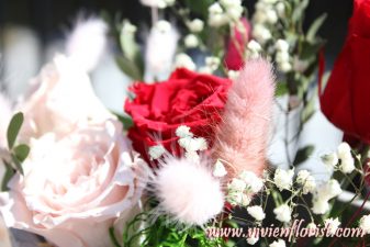 Red and pink eternal roses in clay vase