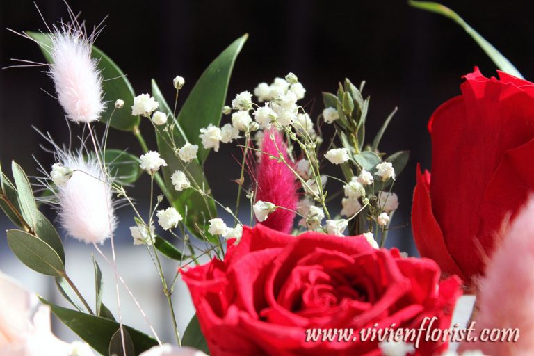 Red and pink eternal roses in clay vase