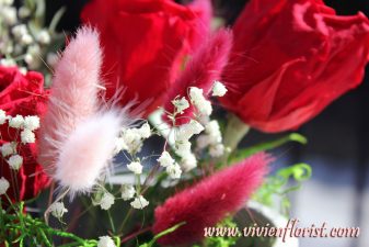 Red and pink eternal roses in clay vase